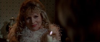 Movie still from “High Plains Drifter” (1973), directed by Clint Eastwood – A person with a candle in a room; Close Up shot, Over the shoulder angle