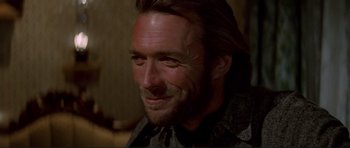 Movie still from “High Plains Drifter” (1973), directed by Clint Eastwood – A person with long hair; Close Up shot, Over the shoulder angle