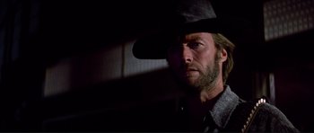 Movie still from “High Plains Drifter” (1973), directed by Clint Eastwood – A person wearing a cowboy hat; Close Up shot, Low angle