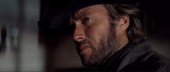 Movie still from “High Plains Drifter” (1973), directed by Clint Eastwood – A person wearing a cowboy hat; Close Up shot, Low angle