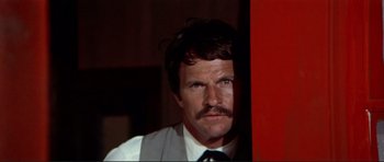 Movie still from “High Plains Drifter” (1973), directed by Clint Eastwood – A person wearing a tie; Close Up shot, Low angle