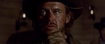 Movie still from “High Plains Drifter” (1973), directed by Clint Eastwood – A person with a cowboy hat on; Close Up shot, Low angle