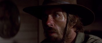 Movie still from “High Plains Drifter” (1973), directed by Clint Eastwood – A person wearing a hat; Close Up shot, Low angle