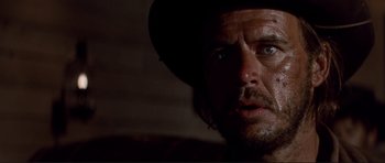 Movie still from “High Plains Drifter” (1973), directed by Clint Eastwood – A person wearing a hat; Close Up shot, Low angle