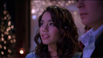 Movie still from “High School Musical” (2006), directed by Kenny Ortega – A woman with long brown curly hair wearing a blue dress; Close Up shot, Over the shoulder angle