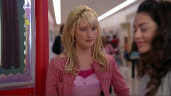 Movie still from “High School Musical” (2006), directed by Kenny Ortega – A woman in a pink dress and a pink jacket; Close Up shot, Over the shoulder angle