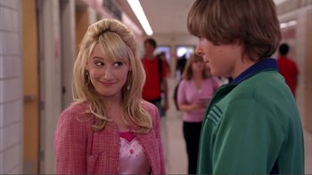Movie still from “High School Musical” (2006), directed by Kenny Ortega – A woman in a pink jacket and a man in a green jacket; Medium shot, Over the shoulder angle