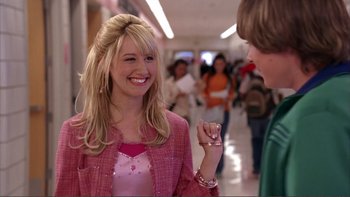 Movie still from “High School Musical” (2006), directed by Kenny Ortega – A woman in a pink jacket talking to a man in a pink jacket; Medium shot, Over the shoulder angle