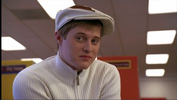Movie still from “High School Musical” (2006), directed by Kenny Ortega – A young man wearing a hat and a white sweater; Close Up shot, Low angle