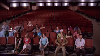 Movie still from “High School Musical” (2006), directed by Kenny Ortega – A group of people sitting in a movie theater; Extreme Wide shot, High angle