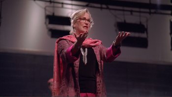 Movie still from “High School Musical” (2006), directed by Kenny Ortega – An older woman wearing glasses and a pink jacket; Close Up shot, Low angle