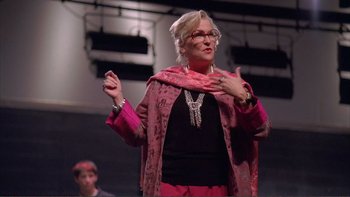 Movie still from “High School Musical” (2006), directed by Kenny Ortega – A woman in a pink jacket and a pink scarf; Medium shot, Low angle