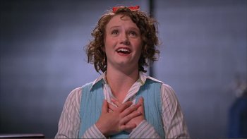 Movie still from “High School Musical” (2006), directed by Kenny Ortega – A woman with curly red hair holding her hands to her chest; Close Up shot, Low angle