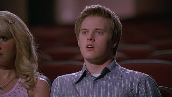 Movie still from “High School Musical” (2006), directed by Kenny Ortega – A young man with blonde hair is looking up; Close Up shot, Low angle
