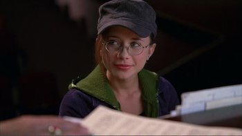 Movie still from “High School Musical” (2006), directed by Kenny Ortega – A woman wearing glasses and a hat looking to her left; Close Up shot, Over the shoulder angle