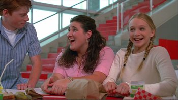 Movie still from “High School Musical” (2006), directed by Kenny Ortega – A group of people sitting at a table with food; Medium shot, Low angle