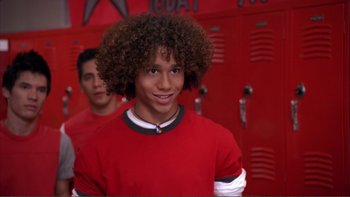 Movie still from “High School Musical” (2006), directed by Kenny Ortega – Two young men in a red room with lockers in the background; Close Up shot, Low angle