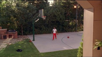 Movie still from “High School Musical” (2006), directed by Kenny Ortega – A young girl is playing basketball on the court; Extreme Wide shot, High angle