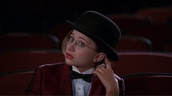 Movie still from “High School Musical” (2006), directed by Kenny Ortega – A young girl wearing a top hat and bow tie; Close Up shot, High angle