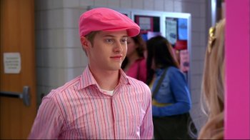 Movie still from “High School Musical 2” (2007), directed by Kenny Ortega – A young man wearing a pink hat and a striped shirt; Close Up shot, Over the shoulder angle