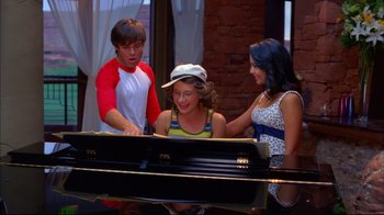 Movie still from “High School Musical 2” (2007), directed by Kenny Ortega – A group of people standing next to each other near a piano; Medium shot, Over the shoulder angle