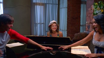 Movie still from “High School Musical 2” (2007), directed by Kenny Ortega – A woman sitting in front of an open piano; Medium shot, Over the shoulder angle