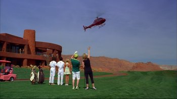 Movie still from “High School Musical 2” (2007), directed by Kenny Ortega – A group of people standing on a field watching a helicopter; Extreme Wide shot, Low angle