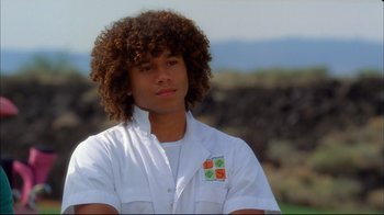 Movie still from “High School Musical 2” (2007), directed by Kenny Ortega – A young man with curly brown hair wearing a white lab coat; Close Up shot, Low angle