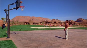 Movie still from “High School Musical 2” (2007), directed by Kenny Ortega – A group of people playing basketball on a court; Extreme Wide shot, Low angle
