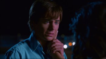 Movie still from “High School Musical 2” (2007), directed by Kenny Ortega – A young man in a blue shirt and tie; Close Up shot, Over the shoulder angle