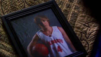 Movie still from “High School Musical 2” (2007), directed by Kenny Ortega – A picture of a young man holding a basketball in a black frame; Close Up shot, High angle