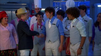 Movie still from “High School Musical 2” (2007), directed by Kenny Ortega – A group of men standing next to each other; Medium shot, Over the shoulder angle