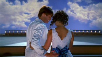 Movie still from “High School Musical 2” (2007), directed by Kenny Ortega – A man and a woman standing next to each other; Medium shot, Low angle