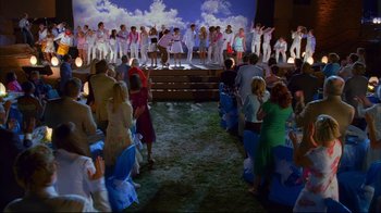Movie still from “High School Musical 2” (2007), directed by Kenny Ortega – A group of people standing in front of a stage; Extreme Wide shot, High angle