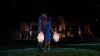 Movie still from “High School Musical 2” (2007), directed by Kenny Ortega – A man and a woman kissing while holding lanterns; Wide shot, Low angle