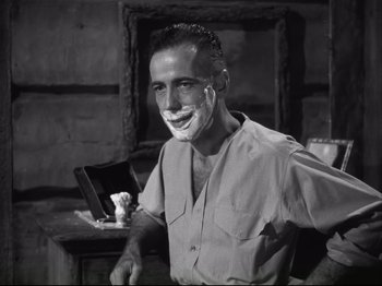 Movie still from “High Sierra” (1940), directed by Raoul Walsh – A black and white photo of a man with shaving cream all over his face; Close Up shot, Over the shoulder angle
