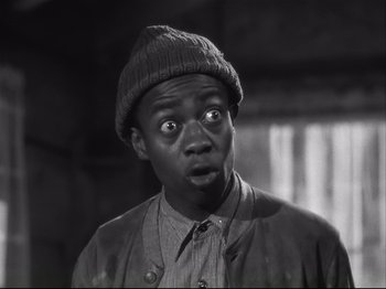 Movie still from “High Sierra” (1940), directed by Raoul Walsh – A black and white photo of a man with a surprised look on his face; Close Up shot, Low angle