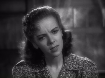 Movie still from “High Sierra” (1940), directed by Raoul Walsh – An old photo of a woman in a floral shirt; Close Up shot, Low angle