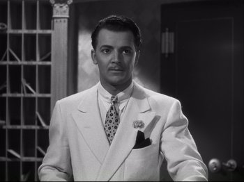 Movie still from “High Sierra” (1940), directed by Raoul Walsh – A black and white photo of a man in a suit and tie; Close Up shot, Low angle