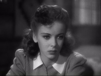 Movie still from “High Sierra” (1940), directed by Raoul Walsh – A black - and - white photo of a woman in a sweater; Close Up shot, High angle