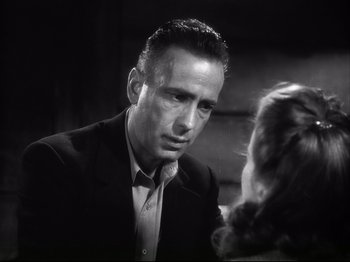 Movie still from “High Sierra” (1940), directed by Raoul Walsh – A black and white photo of a man and a woman; Close Up shot, Low angle