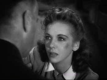 Movie still from “High Sierra” (1940), directed by Raoul Walsh – An old black and white photo of a woman and a man; Close Up shot, High angle