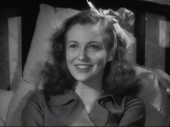 Movie still from “High Sierra” (1940), directed by Raoul Walsh – An old photo of a woman smiling for the camera; Close Up shot, High angle