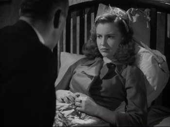 Movie still from “High Sierra” (1940), directed by Raoul Walsh – A woman sitting in a bed next to a man in a suit; Close Up shot, High angle