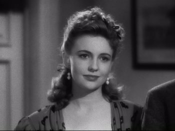 Movie still from “High Sierra” (1940), directed by Raoul Walsh – A black and white photo of a woman in a dress; Close Up shot, Over the shoulder angle