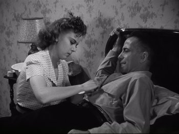 Movie still from “High Sierra” (1940), directed by Raoul Walsh – An old photo of a man and a woman; Medium shot, High angle