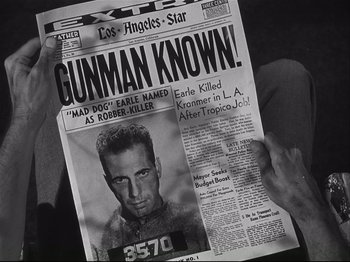 Movie still from “High Sierra” (1940), directed by Raoul Walsh – A person is reading a newspaper with a picture of a man; Extreme Close Up shot, Over the shoulder angle