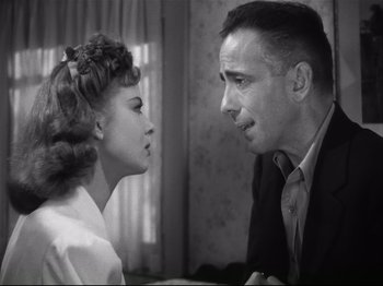 Movie still from “High Sierra” (1940), directed by Raoul Walsh – An old photo of a man and a woman looking at each other; Close Up shot, Over the shoulder angle