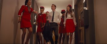Movie still from “High-Rise” (2015), directed by Ben Wheatley – A group of people dressed in red and white uniforms; Wide shot, Low angle