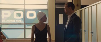 Movie still from “High-Rise” (2015), directed by Ben Wheatley – A man and a woman standing next to each other in a room; Medium shot, Over the shoulder angle